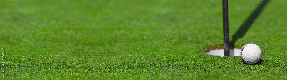 golf ball on lip of cup