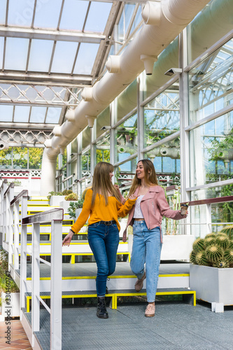 Two friends walk through a park and tell each other their secrets