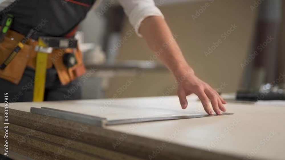 closeup, worker draws a line at a corner