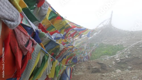 Tibetan prayer flags on the Himalayas in the fog photo