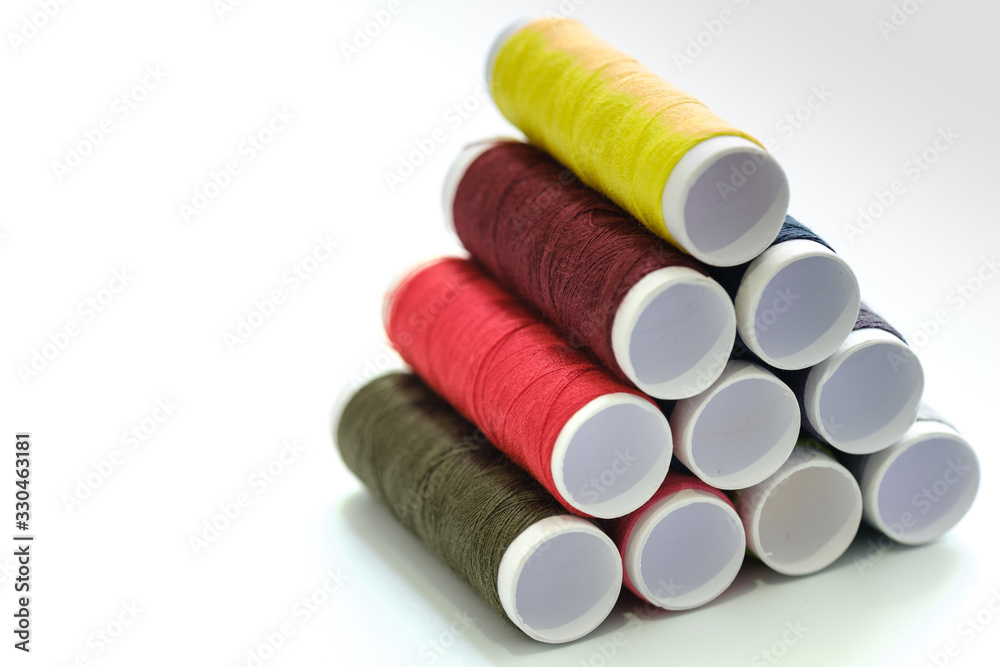 Close up macro view of colorful yarn reels on white background Close up macro view of colorful yarn reels on white background