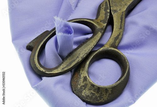 old scissors on fabric background