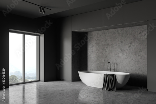 Bathtub in gray loft bathroom corner