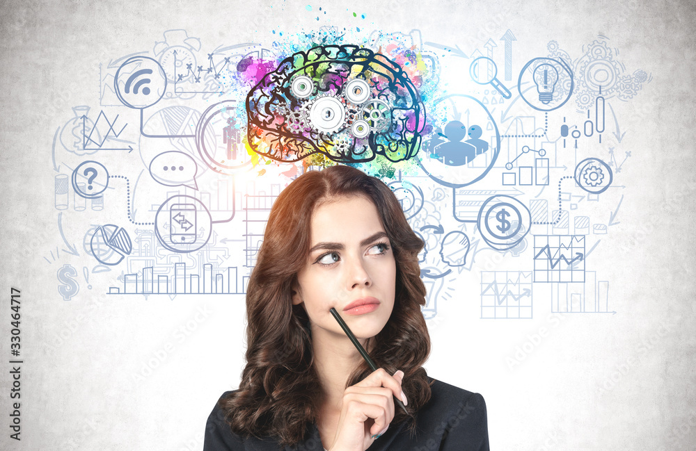 Young businesswoman with pen brainstorming