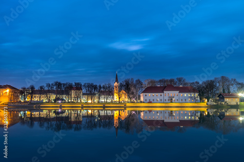 City at night and its reflection in a river. Sisak, Croatia