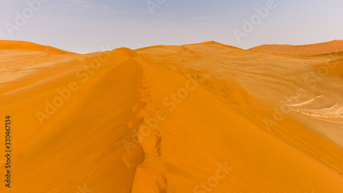 footprints on the crest of a dune at Sossusvlei in Namibia