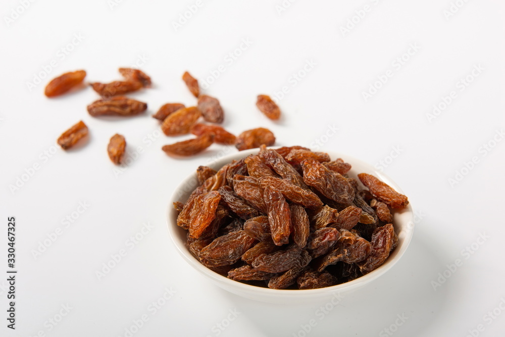 Fototapeta premium Orange raisins dry in the sun and stand alone on a white background