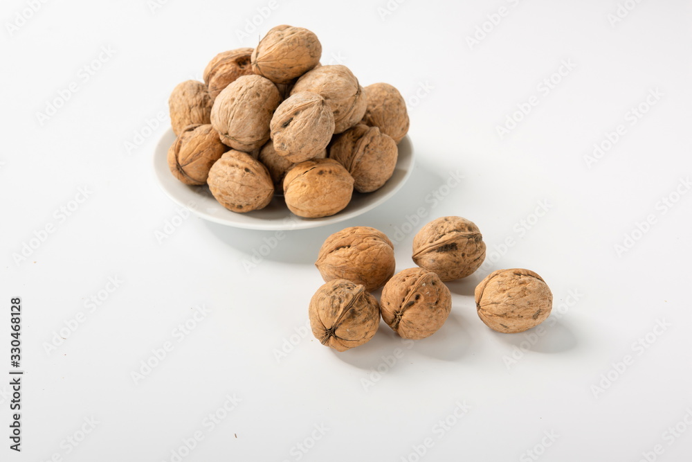 Walnut with shell is isolated on white background after drying Walnut with shell is isolated on white background after drying