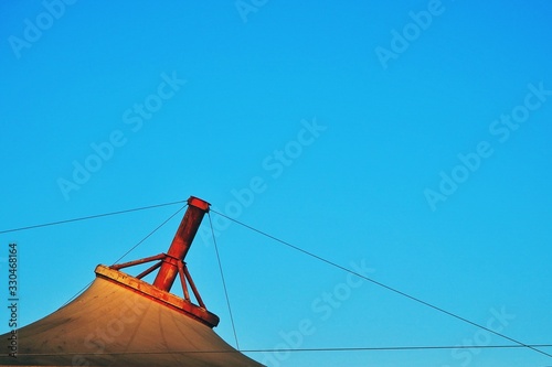 Modern red steel structure canvas roof with bright blue sky