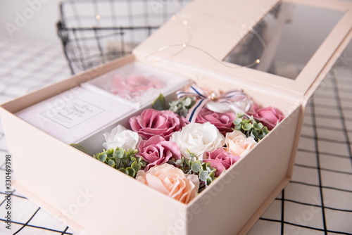 Colorful rose flower gift box with fluorescent lights around. It's a good way to propose