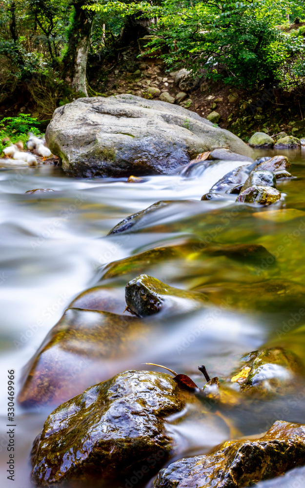 panoramic long exposure photo of a river with beautiful rocks. panoramic long exposure photo of a river with beautiful rocks.