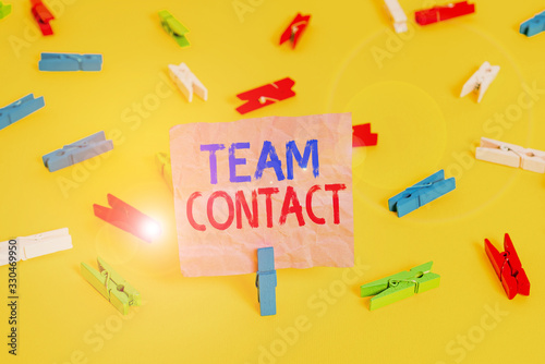 Handwriting text Team Contact. Conceptual photo The interaction of the individuals on a team or group Colored clothespin papers empty reminder yellow floor background office photo