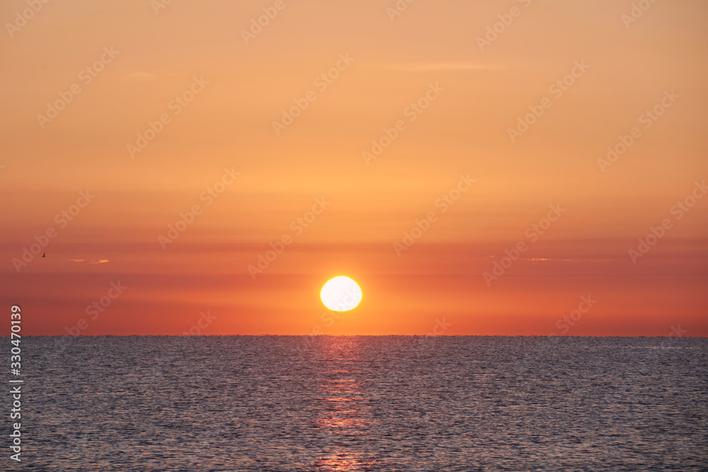 Fishermen on the beach groyne at sunrise,