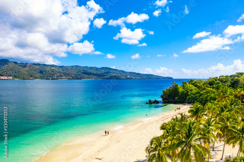 Fototapeta Naklejka Na Ścianę i Meble -  Aerial drone view of beautiful caribbean tropical island Cayo Levantado beach with palms. Bacardi Island, Dominican Republic. Vacation background.