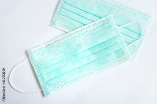 Green mask for protection against germs and viruses ( coronavirus ,covid-19).On a white background.