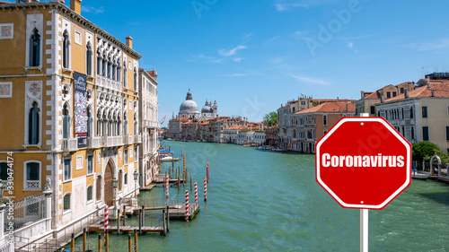 A stop sign subtitle coronavirus covid-19 that causes the pandemic represents foregone tourists in Venice Italy