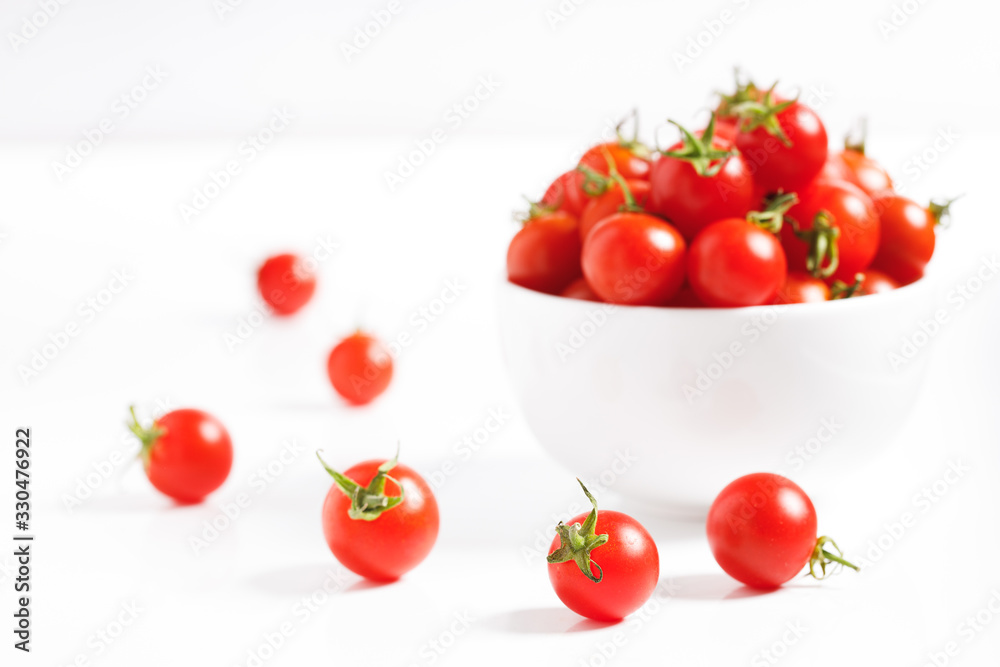 red cherry tomato in ceramic bowl on white background red cherry tomato in ceramic bowl on white background