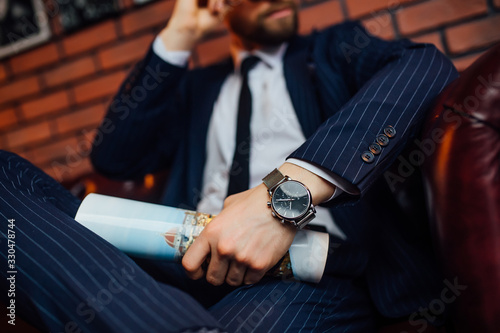 Close up photo ,watch on hand businessman, time on watch, dark tone.