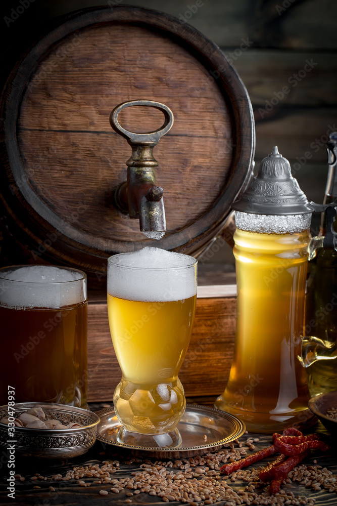 Light beer in a glass, on an old background. Light beer in a glass, on an old background.