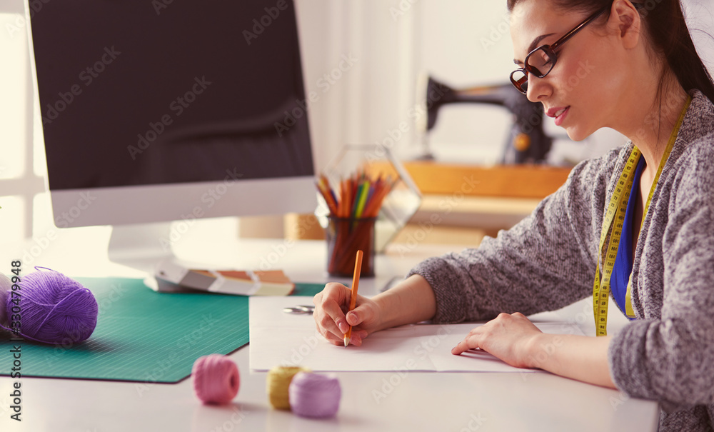 Beautiful fashion woman designer standing in studio Beautiful fashion woman designer standing in studio