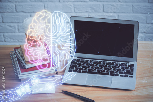 Double exposure of table with computer and brain hologram. Data innovation concept.