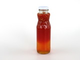 Chicken dipping sauce in a glass jar isolated on a white background.
