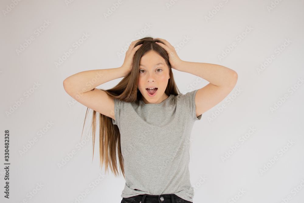 Astonished girl with her hands on head