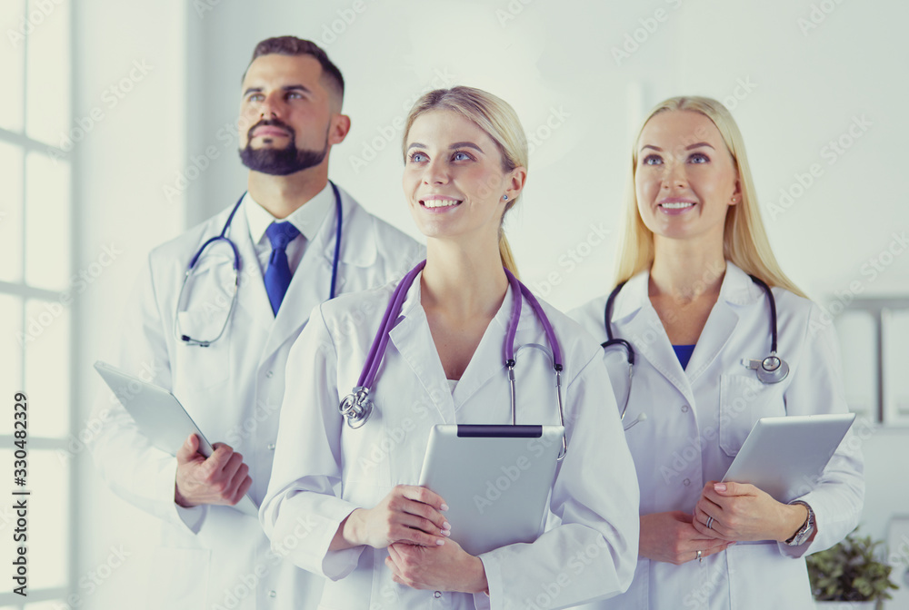 Smiling doctors all standing together as they work Smiling doctors all standing together as they work