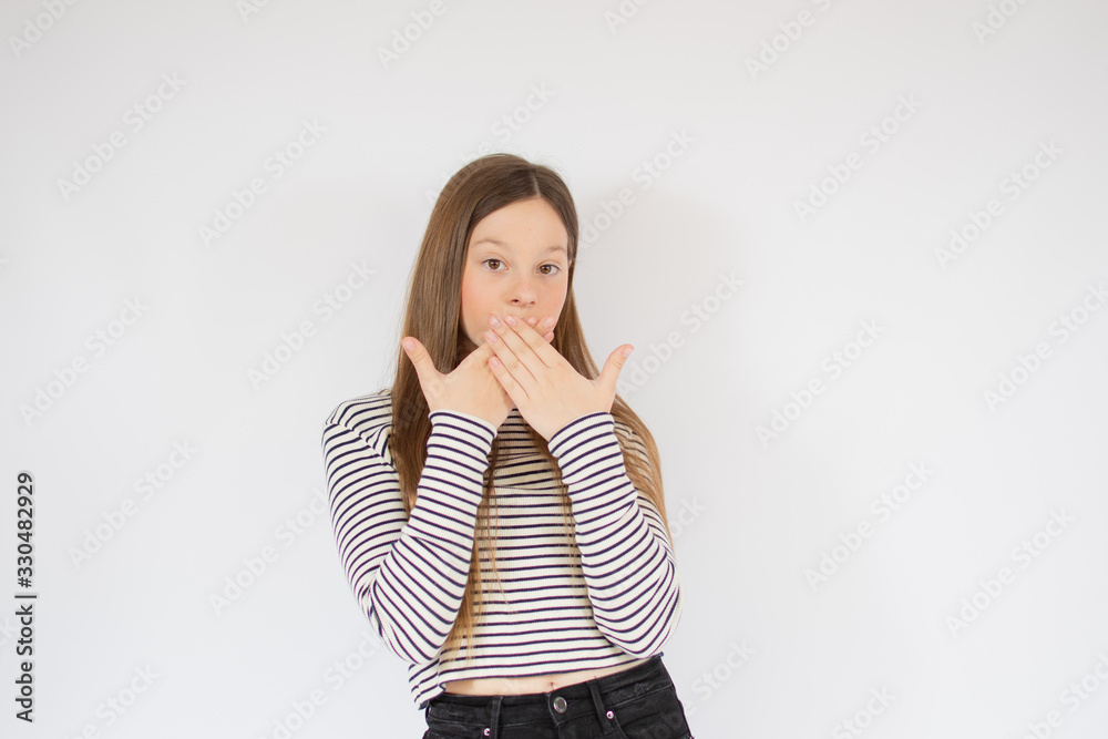 Girl with striped shirt covering her mouth Girl with striped shirt covering her mouth