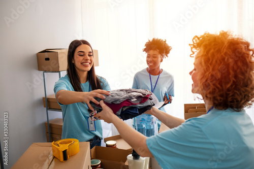 Small group of people working on humanitarian aid project. Group of mixed race people working in charitable foundation. We love to help other people. Generous people helping to poor people