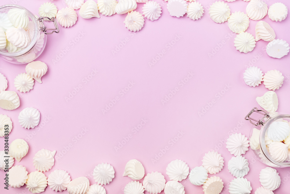 Small Meringue and Flass Jars with Small Meringues on Pink Background Flat Lay Top View Copy Space Small Meringue and Flass Jars with Small Meringues on Pink Background Flat Lay Top View Copy Space
