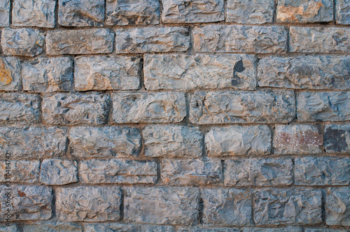 textured wall of gray brick for background