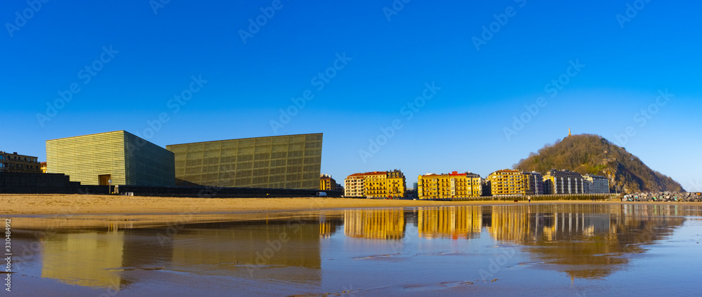 Fototapeta premium buildings are reflected in the water of the beach, Zurriola, Ciudad de Donostia, Euskadi