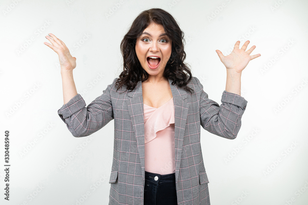 joyful winner in a gray checkered jacket on a white studio background joyful winner in a gray checkered jacket on a white studio background