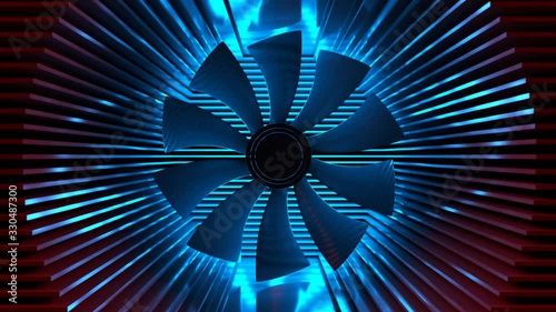 A fan among the radiator plates. Cooling system closeup colored backlight. Fan with an aluminum radiator on a black background.