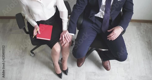 Man Touching Woman's Knee, Sexual Harassment In Business Office, Love Affair At Work photo