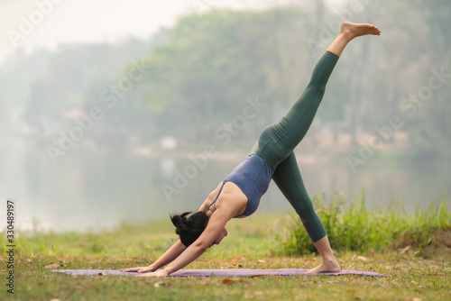 Young girl doing yoga fitness exercise outdoor