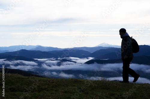 Hiker contemplating the mountains with sea of clouds from the natural park of Aiako Harriak  Euskadi