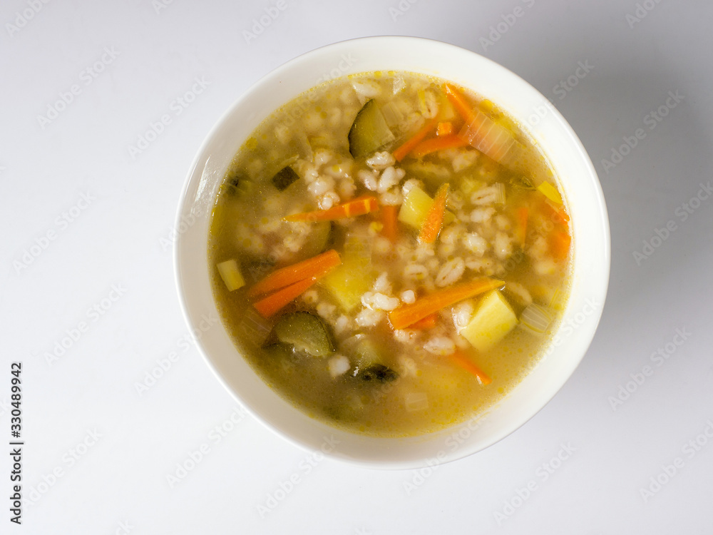 Russian soup Rassolnik in a white deep plate. View from above