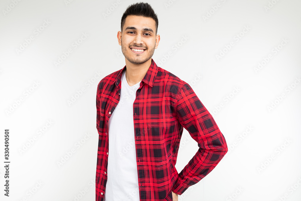 confident brutal man in a checkered shirt wide open on a white studio background with copy space confident brutal man in a checkered shirt wide open on a white studio background with copy space