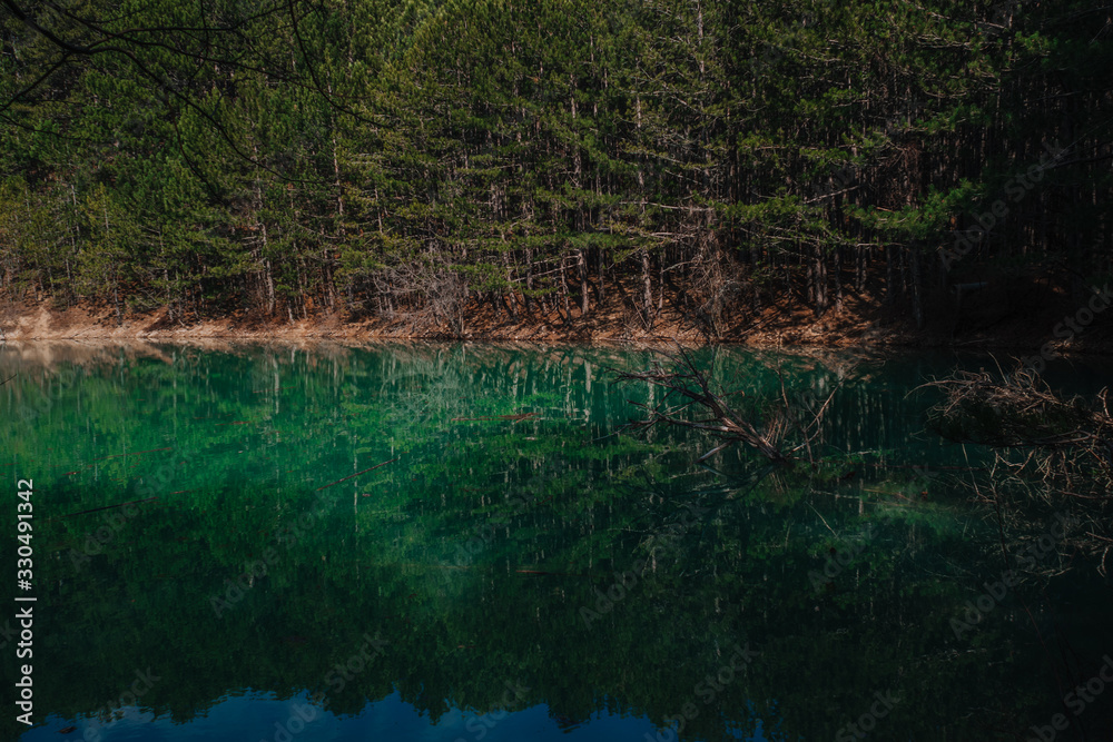 Lake, turquoise water color, mysterious lake in the mountains of Crimea, reflections in the water. Lake, turquoise water color, mysterious lake in the mountains of Crimea, reflections in the water.