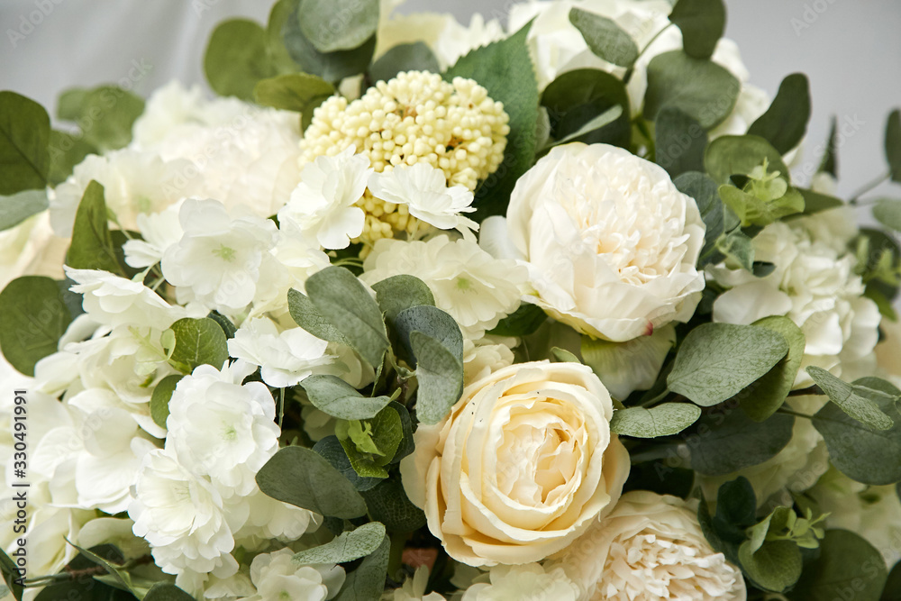 Fototapeta premium A large beautiful bouquet of white flowers with greenery. Natural, fresh flowers.