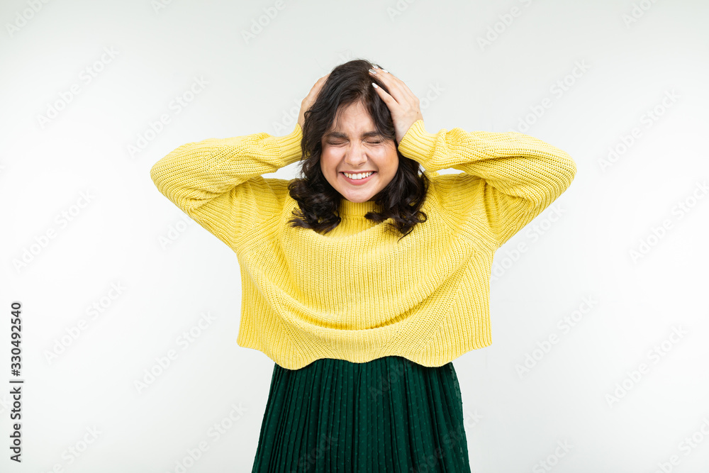 joyful happy brunette girl in a yellow sweater and green skirt on a white background joyful happy brunette girl in a yellow sweater and green skirt on a white background