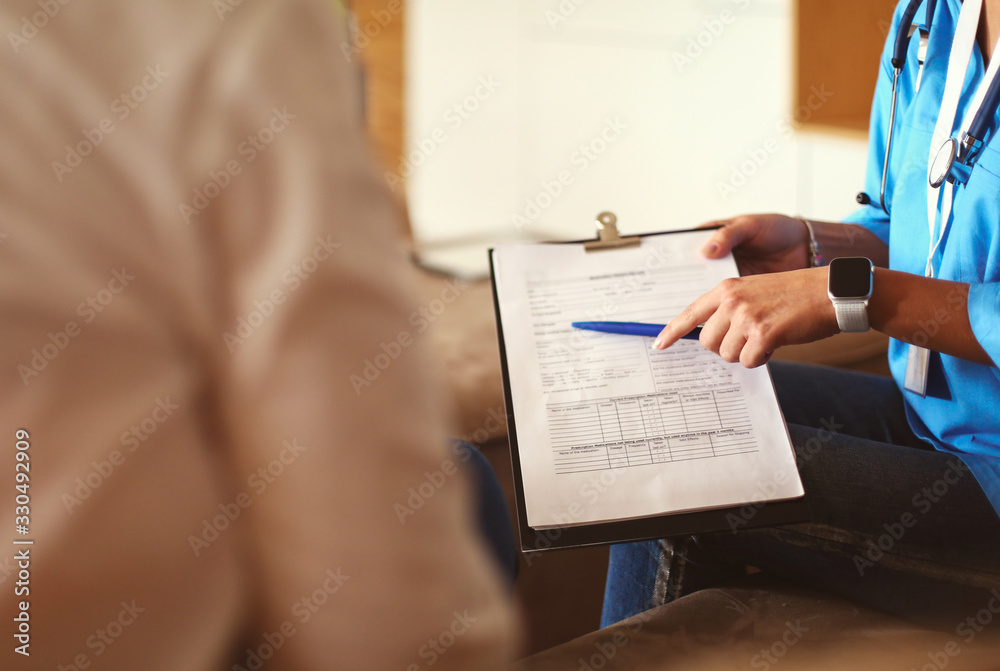 A doctor is talking and examining a patient A doctor is talking and examining a patient