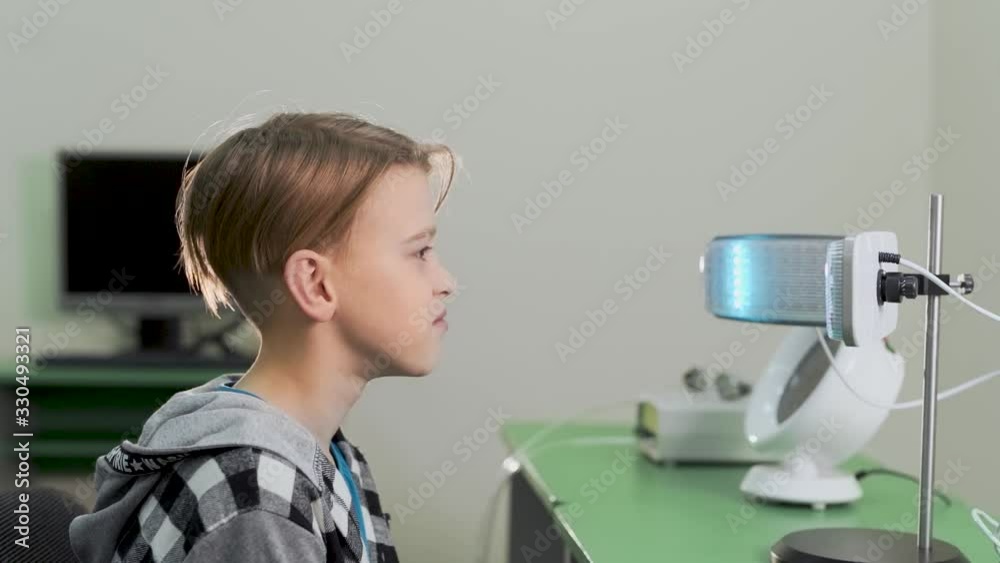 a modern vision rehabilitation clinic, the guy deals with a special device