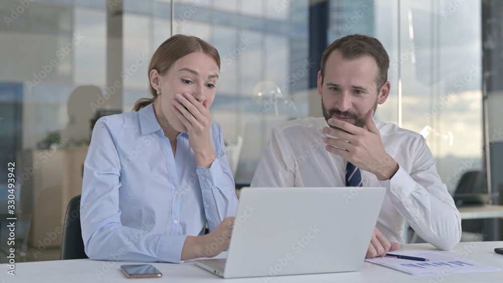 The Excited Business people Surprised while Working on Laptop The Excited Business people Surprised while Working on Laptop