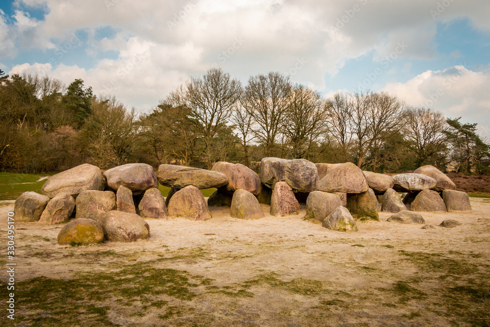 A hunebed in the Holtingerveld near Havelte in the province of Drenthe, ancient prehistoric stones from the ice age and later used as a grave by the Hunen, people also from ancient times