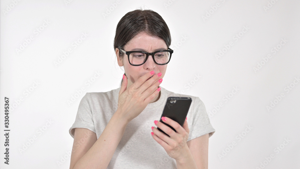 The Sad Young Woman Feeling Disappointed While Looking at Phone on White Background The Sad Young Woman Feeling Disappointed While Looking at Phone on White Background