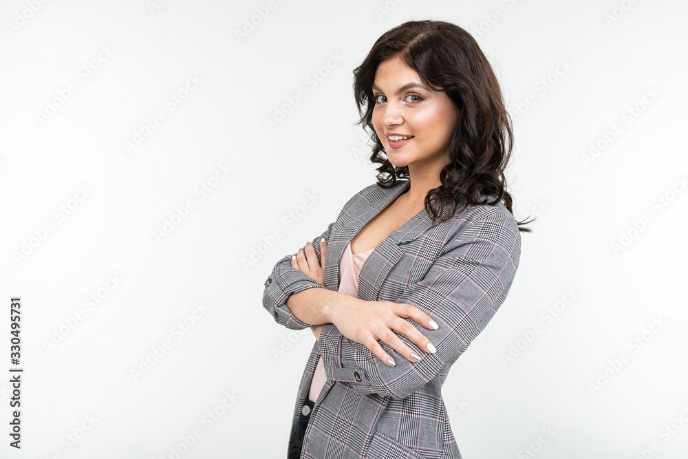 charming brunette woman in a checkered gray jacket for office on a white background with copy space charming brunette woman in a checkered gray jacket for office on a white background with copy space