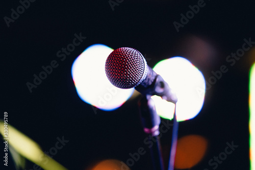 Concert microphone on a stand in front of the light